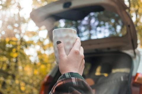 Cup of coffee on the background of the car. Stock Photos