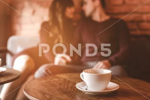 The cup of coffee on the background of the couple Stock Photos
