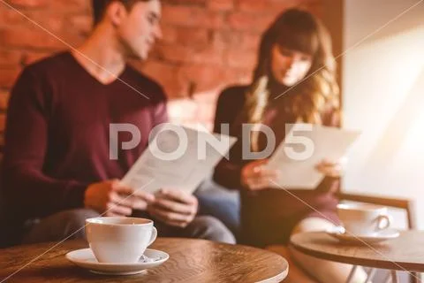 The cup of coffee on the background of the couple Stock Photos