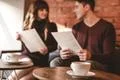 The cup of coffee on the background of the sitting couple Photo