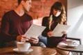 The cup of coffee on the background of the sitting couple Photo