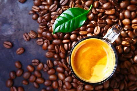 Cup of coffee with beans and leaf Stock Photos
