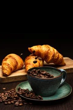 Cup with coffee beans on a black background Stock Photos