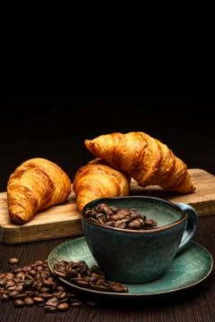 Cup with coffee beans on a black background Stock Photos
