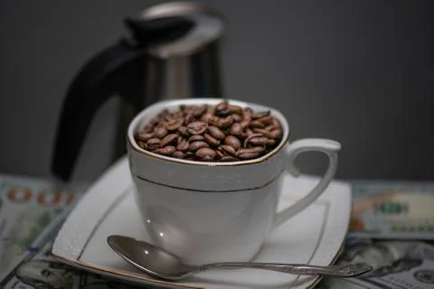 Cup of coffee beans on grey background Stock Photos