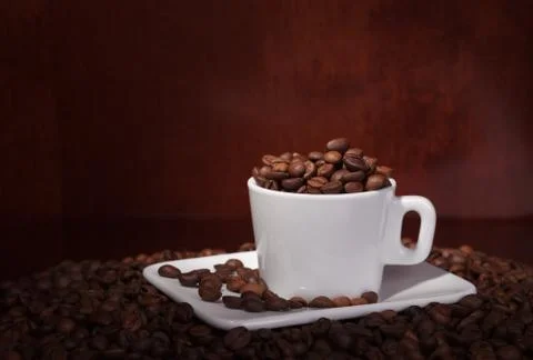 Cup with coffee beans Stock Photos