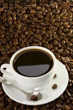 Cup of coffee at beans Stock Photos