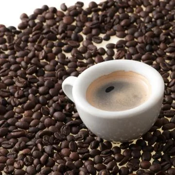 Cup of coffee with beans Stock Photos