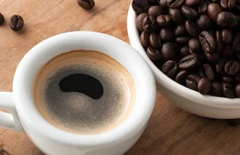 Cup of coffee with beans Stock Photos