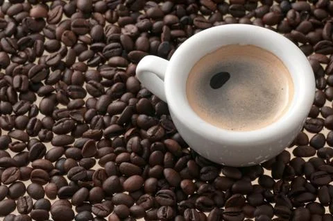 Cup of coffee with beans Stock Photos
