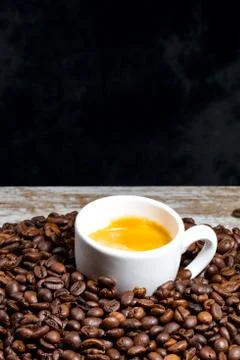 Cup of coffee on beans Stock Photos