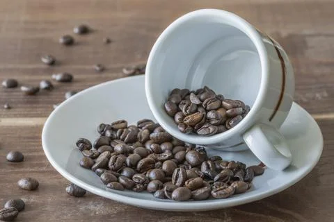 A cup of coffee with beans Stock Photos