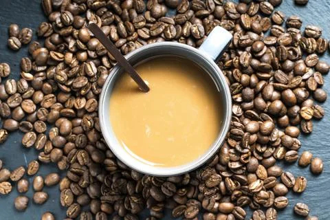 Cup of coffee with beans Stock Photos