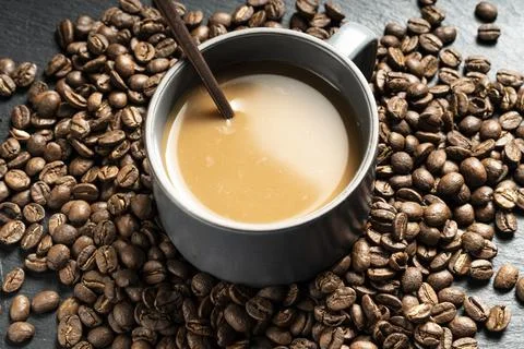 Cup of coffee with beans Stock Photos