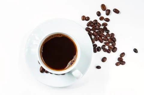 Cup of coffee with beans on white background. Stock Photos
