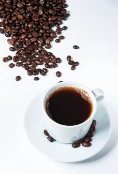 Cup of coffee with beans on white background. Stock Photos
