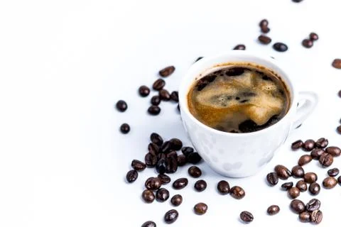 Cup with coffee beans on white background Stock Photos