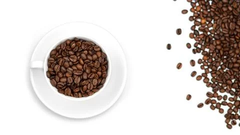A Cup with coffee beans on a white background. Lots of coffee beans. Stock Photos