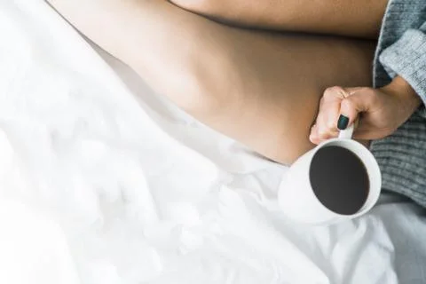 Cup of coffee in bed copy space top view White light tinting 스톡 사진