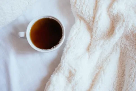 Cup of coffee in bed Stock Photos