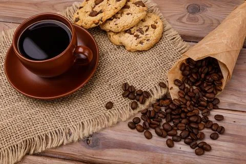 Cup of coffee with biscuits and coffee beans Stock Photos