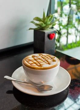 A cup of  coffee on a black table Stock Photos