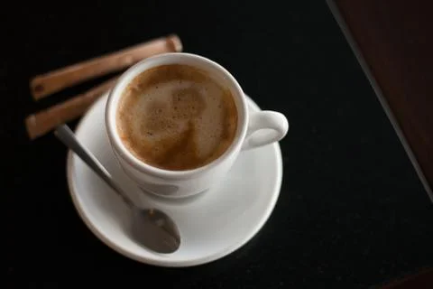Cup of coffee on the black table. Stock Photos