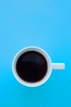 A cup of coffee on blue background Stock Photos