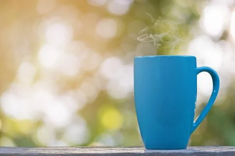 A cup of coffee in bokeh background Stock Photos
