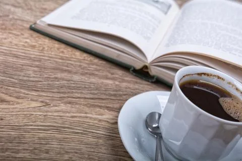 A cup of coffee with a book Stock Photos