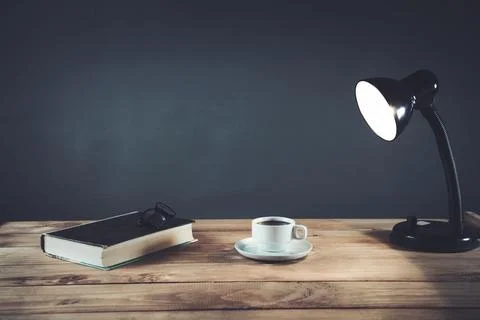 Cup of coffee with book on the table Stock Photos