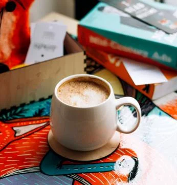 A cup of coffee with books on the table Stock Photos