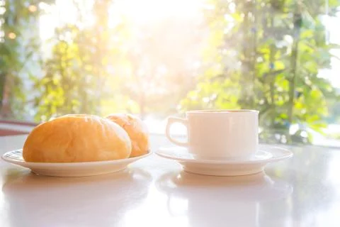 Cup of coffee with bread on the table 스톡 사진