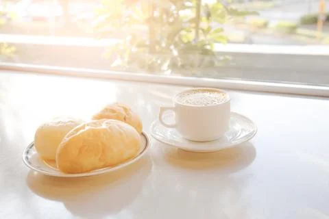 Cup of coffee with bread on the table Stock Photos