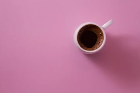 Cup of coffee on a bright background of light violet. Stock Photos