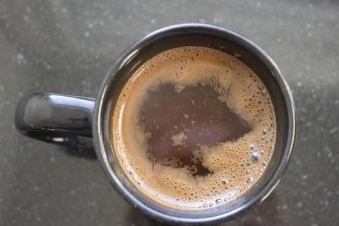 A cup of coffee with brown liquid Stock Photos