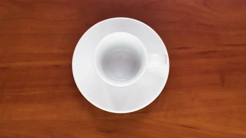 Cup of coffee on a brown table Stockbeeldmateriaal 184469541