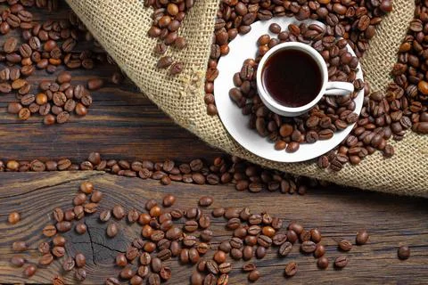 Cup of Coffee on Burlap with Beans Stock Photos