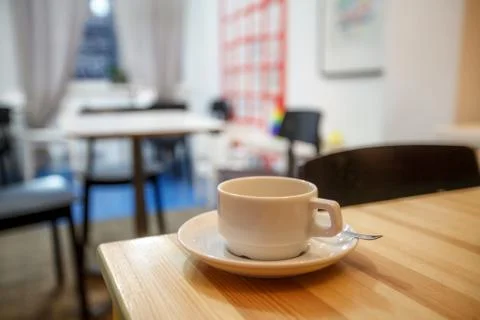 Cup of coffee in cafe on the table, blurred background Stock Photos