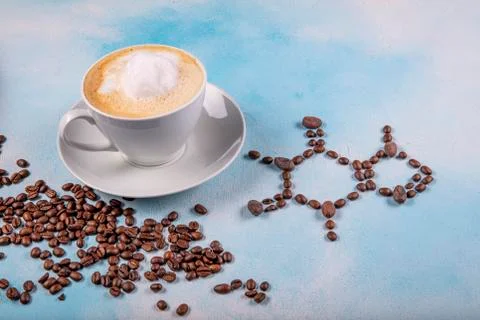 A cup of coffee with caffeine molecule created by coffee beans. Stock Photos