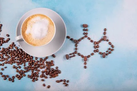 A cup of coffee with caffeine molecule created by coffee beans. Stock Photos