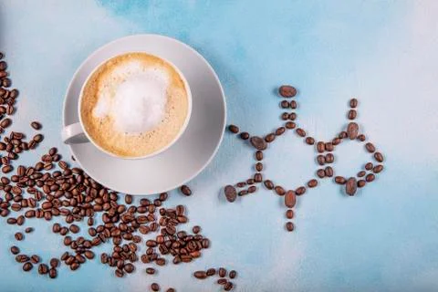 A cup of coffee with caffeine molecule created by coffee beans. Stock Photos