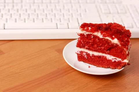 A cup of coffee, cake and a computer keyboard. Stock Photos