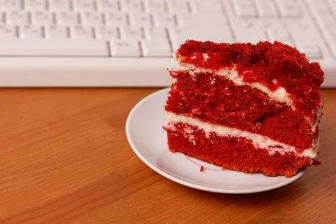 A cup of coffee, cake and a computer keyboard. 스톡 사진