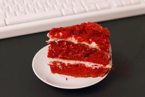 A cup of coffee, cake and a computer keyboard. Stock Photos