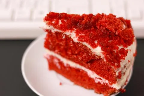 A cup of coffee, cake and a computer keyboard. Stock Photos