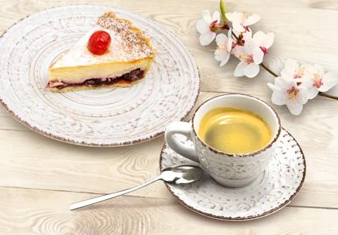 Cup of coffee, cake and spring blossom brunch on wooden desk Stock Photos