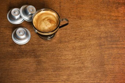 Cup of coffee with capsules Stock Photos