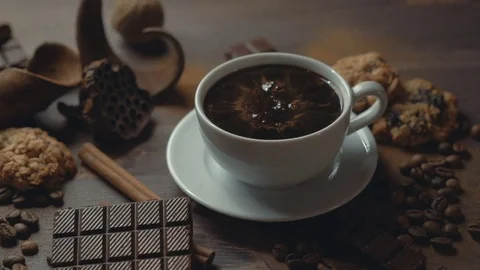Cup of coffee cinnamon sticks and anise star on old wooden table. Stock Footage 82296431