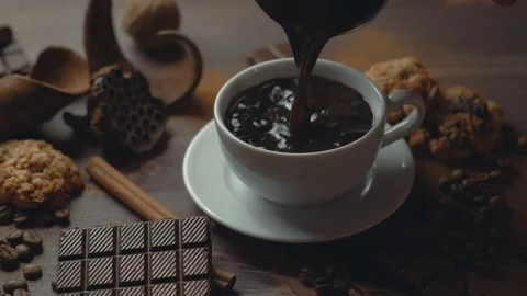Cup of coffee cinnamon sticks, chocolate slices and anise star on old wooden Stock Footage 82189682